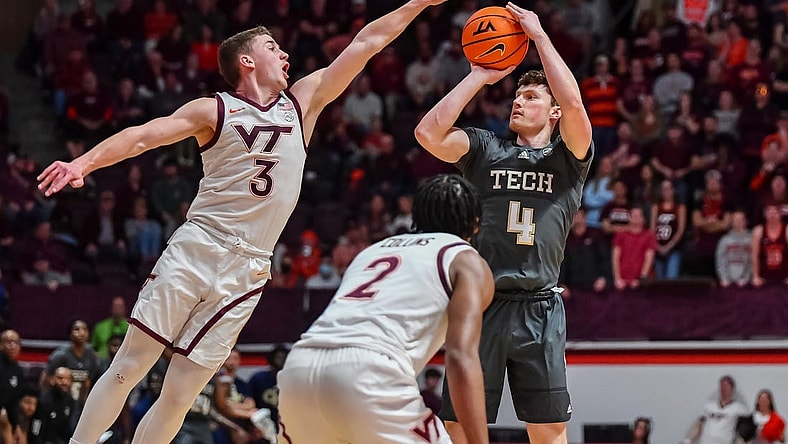 Jan 27, 2024; Blacksburg, Virginia, USA; Georgia Tech Yellow Jackets guard Carter Murphy (4) shoots while being defended by Virginia Tech Hokies guard Sean Pedulla (3) during the first half at Cassell Coliseum. Mandatory Credit: Brian Bishop-USA TODAY Sports
