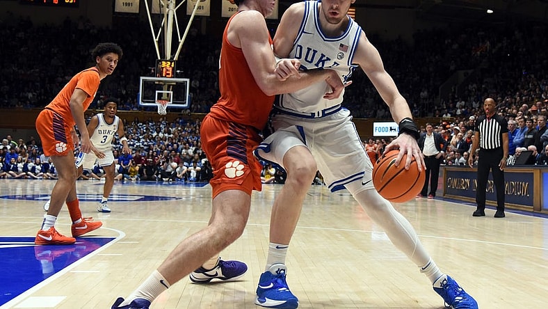 Jan 27, 2024; Durham, North Carolina, USA; Duke Blue Devils center Kyle Filipowski (30) controls the ball in front of Clemson Tigers center PJ Hall (24) during the second half at Cameron Indoor Stadium. Mandatory Credit: Rob Kinnan-USA TODAY Sports