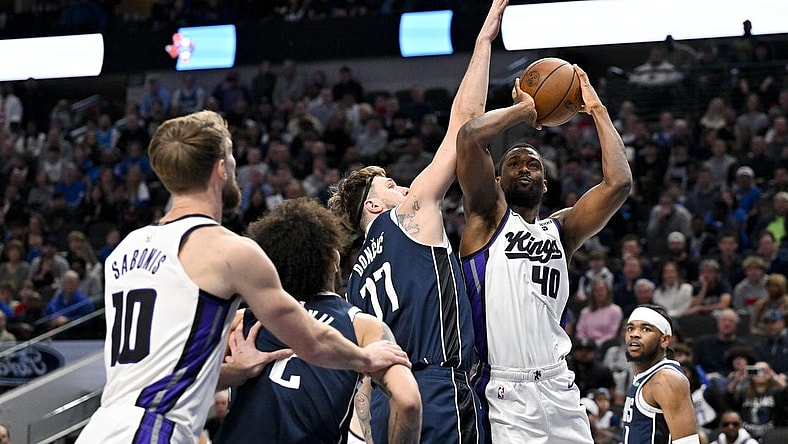 Jan 27, 2024; Dallas, Texas, USA; Sacramento Kings forward Harrison Barnes (40) looks to shoot over Dallas Mavericks guard Luka Doncic (77) during the first quarter at the American Airlines Center. Mandatory Credit: Jerome Miron-USA TODAY Sports