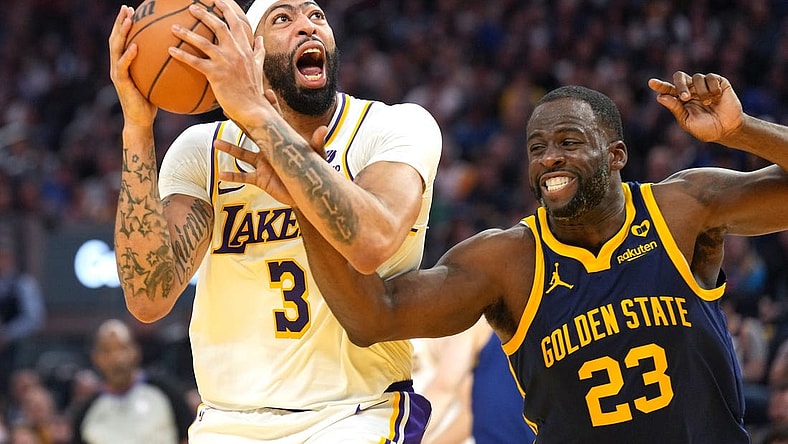 Jan 27, 2024; San Francisco, California, USA; Los Angeles Lakers forward Anthony Davis (3) shoots while being fouled by Golden State Warriors forward Draymond Green (23) during the second quarter at Chase Center. Mandatory Credit: Darren Yamashita-USA TODAY Sports