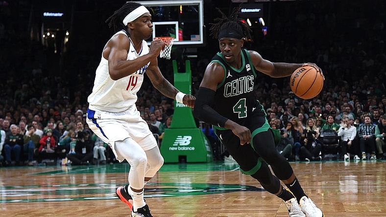 Jan 27, 2024; Boston, Massachusetts, USA;  Boston Celtics guard Jrue Holiday (4) controls the ball while LA Clippers guard Terance Mann (14) defends during the second half at TD Garden. Mandatory Credit: Bob DeChiara-USA TODAY Sports