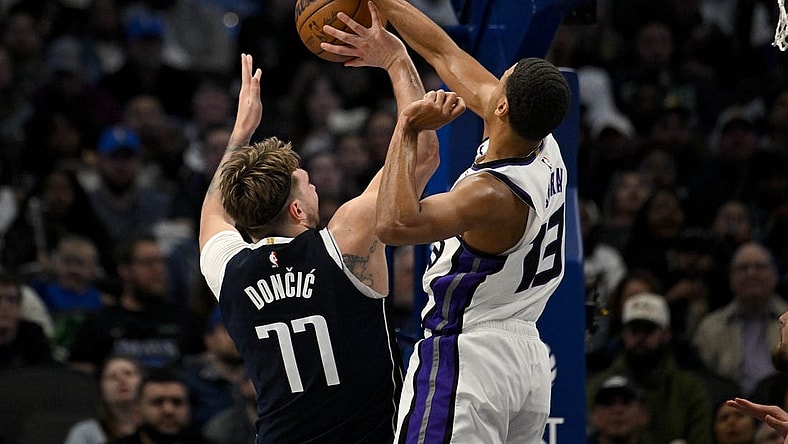 Jan 27, 2024; Dallas, Texas, USA; Sacramento Kings forward Keegan Murray (13) blocks a shot by Dallas Mavericks guard Luka Doncic (77) during the second quarter at the American Airlines Center. Mandatory Credit: Jerome Miron-USA TODAY Sports