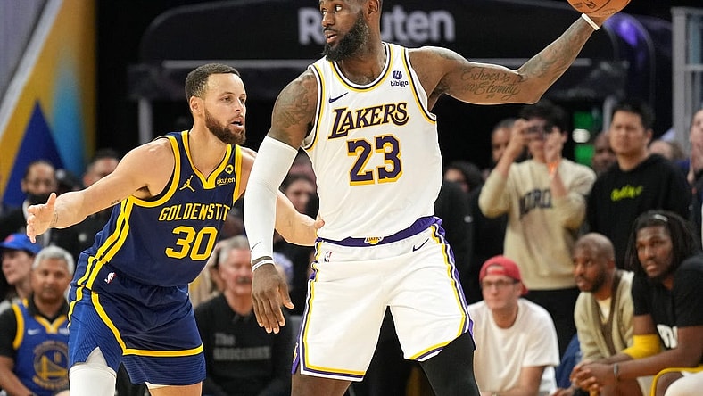 Jan 27, 2024; San Francisco, California, USA; Golden State Warriors forward Draymond Green (23) handles the ball against Golden State Warriors guard Stephen Curry (30) during overtime at Chase Center. Mandatory Credit: Darren Yamashita-USA TODAY Sports