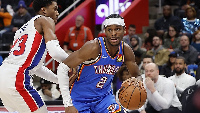 Jan 28, 2024; Detroit, Michigan, USA; Oklahoma City Thunder guard Shai Gilgeous-Alexander (2) dribbles defended by Detroit Pistons guard Jaden Ivey (23) in the first half at Little Caesars Arena. Mandatory Credit: Rick Osentoski-USA TODAY Sports