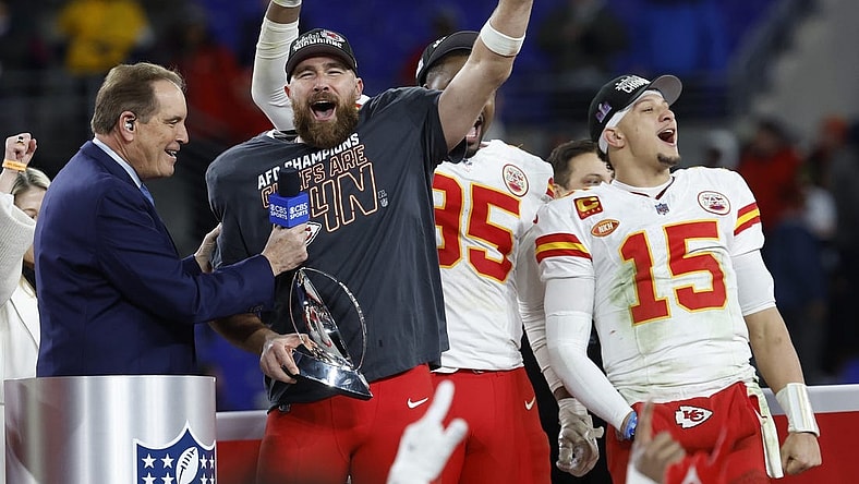 Jan 28, 2024; Baltimore, Maryland, USA; Kansas City Chiefs tight end Travis Kelce (M) celebrates with the Lamar Hunt Trophy while speaking with CBS broadcaster Jim Nance during the trophy presentation after the Chiefs' game against the Baltimore Ravens in the AFC Championship football game at M&T Bank Stadium. Mandatory Credit: Geoff Burke-USA TODAY Sports