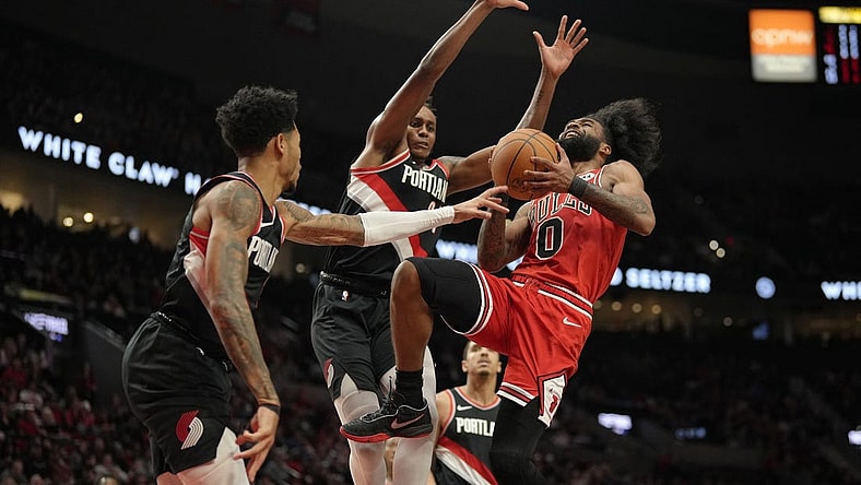 Jan 28, 2024; Portland, Oregon, USA; Chicago Bulls point guard Coby White (0) drives to the basket as he is fouled by Portland Trail Blazers shooting guard Anfernee Simons (1, left) during the first half at Moda Center. Mandatory Credit: Soobum Im-USA TODAY Sports