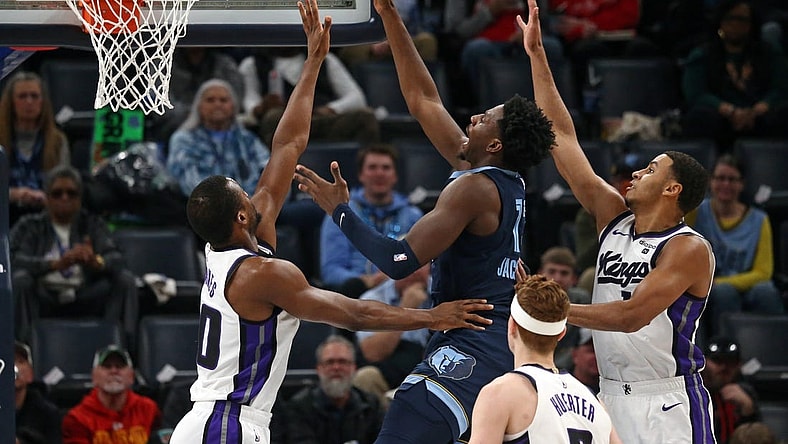 Jan 29, 2024; Memphis, Tennessee, USA; Memphis Grizzlies forward-center Jaren Jackson Jr. (13) shoots between Sacramento Kings forward Harrison Barnes (40)and Sacramento Kings forward Keegan Murray (13) during the first half at FedExForum. Mandatory Credit: Petre Thomas-USA TODAY Sports