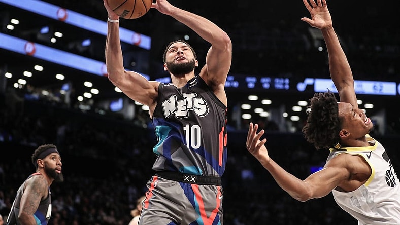 Jan 29, 2024; Brooklyn, New York, USA;  Brooklyn Nets guard Ben Simmons (10) grabs a rebound past Utah Jazz guard Collin Sexton (2) in the second quarter against the Utah Jazz at Barclays Center. Mandatory Credit: Wendell Cruz-USA TODAY Sports