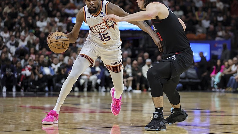 Jan 29, 2024; Miami, Florida, USA; Phoenix Suns forward Kevin Durant (35) moves to the basket against Miami Heat guard Jaime Jaquez Jr. (11) during the second quarter at Kaseya Center. Mandatory Credit: Sam Navarro-USA TODAY Sports