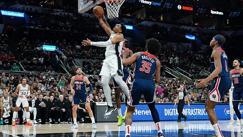 Jan 29, 2024; San Antonio, Texas, USA;  San Antonio Spurs forward Keldon Johnson (3) goes up for a shot in front of Washington Wizards forward Marvin Bagley III (35) in the first half at Frost Bank Center. Mandatory Credit: Daniel Dunn-USA TODAY Sports