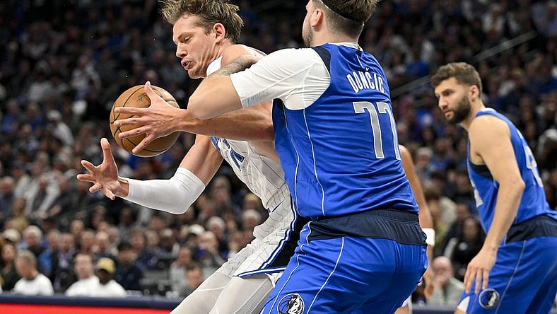Jan 29, 2024; Dallas, Texas, USA; Dallas Mavericks guard Luka Doncic (77) attempts to knock the ball away from Orlando Magic center Moritz Wagner (21) during the second quarter at the American Airlines Center. Mandatory Credit: Jerome Miron-USA TODAY Sports