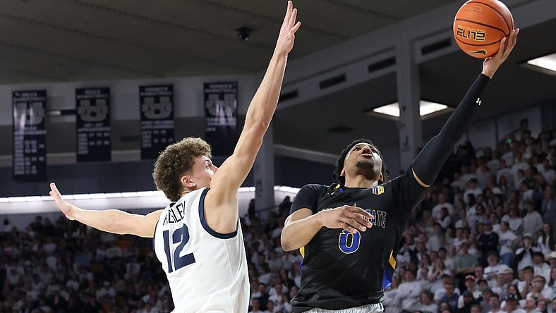 Jan 30, 2024; Logan, Utah, USA; San Jose State Spartans guard Myron Amey Jr. (0) lays the ball up against Utah State Aggies guard Mason Falslev (12) during the first half at Dee Glen Smith Spectrum. Mandatory Credit: Rob Gray-USA TODAY Sports