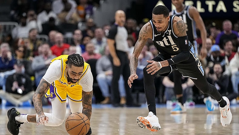 Jan 30, 2024; Atlanta, Georgia, USA; Los Angeles Lakers guard D'Angelo Russell (1) loses and dives for the ball next to Atlanta Hawks guard Dejounte Murray (5) during the second half at State Farm Arena. Mandatory Credit: Dale Zanine-USA TODAY Sports