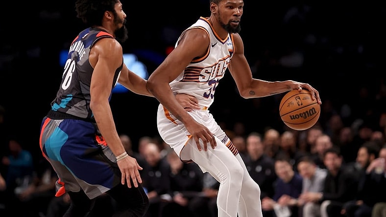 Jan 31, 2024; Brooklyn, New York, USA; Phoenix Suns forward Kevin Durant (35) controls the ball against Brooklyn Nets guard Spencer Dinwiddie (26) during the second quarter at Barclays Center. Mandatory Credit: Brad Penner-USA TODAY Sports