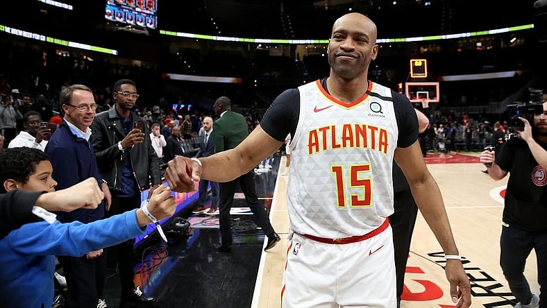 Mar 11, 2020; Atlanta, Georgia, USA; Atlanta Hawks guard Vince Carter (15) fist bumps fans after an overtime loss to the New York Knicks at State Farm Arena. Mandatory Credit: Jason Getz-USA TODAY Sports