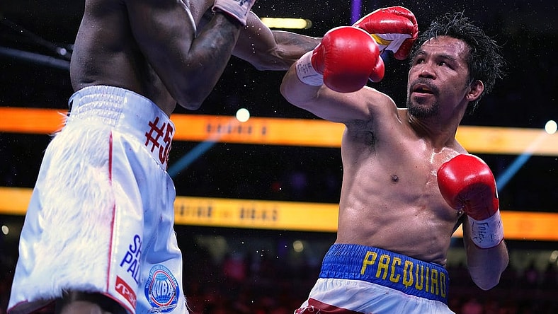 Aug 21, 2021; Las Vegas, Nevada; Manny Pacquiao (right) fights Yordenis Ugas in a world welterweight championship bout at T-Mobile Arena. Mandatory Credit: Stephen R. Sylvanie-USA TODAY Sports