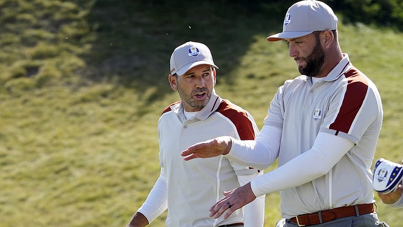 Sep 25, 2021; Haven, Wisconsin, USA; Team Europe player Sergio Garcia talks with Team Europe player Jon Rahm after a missed putt on the sixth green during day two four-ball rounds for the 43rd Ryder Cup golf competition at Whistling Straits. Mandatory Credit: Michael Madrid-USA TODAY Sports
