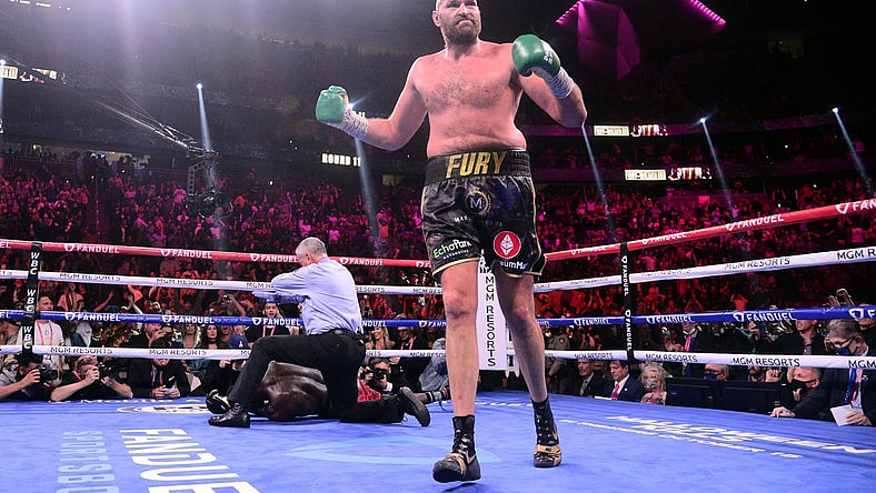 Oct 9, 2021; Las Vegas, Nevada, USA; Deontay Wilder (red/black trunks) is knocked out by Tyson Fury (black/gold trunks) during their WBC/Lineal heavyweight championship boxing match at T-Mobile Arena. Mandatory Credit: Joe Camporeale-USA TODAY Sports