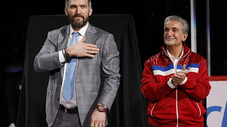 Apr 26, 2022; Washington, District of Columbia, USA; Injured Washington Capitals left wing Alex Ovechkin (L) gestures to fans while standing next to Capitals owner Ted Leonsis (R) during a ceremony honoring his becoming 3rd highest goal scorer in NHL history prior to the Capitals game against the New York Islanders at Capital One Arena. Mandatory Credit: Geoff Burke-USA TODAY Sports