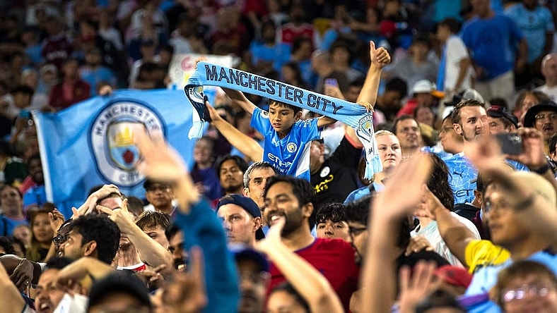 A young fan holds a "Manchester City" scarf after the exhibition match between FC Bayern Munich and Manchester City on Saturday, July 23, 2022, at Lambeau Field in Green Bay, Wis.

Gpg Bayern Man City Match 7232022 0004