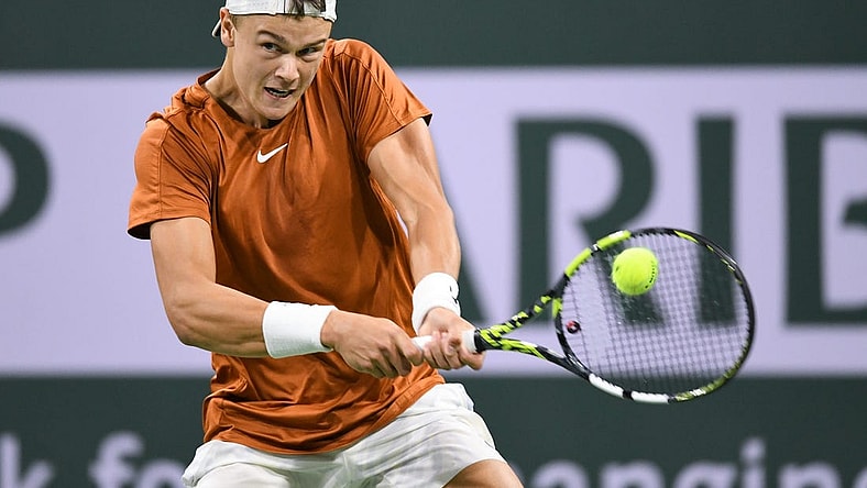 Mar 11, 2023; Indian Wells, CA, USA; Holger Rune (DEN) hits a backhand during his second round match against Mackenzie McDonald (USA) during the BNP Paribas Open at Indian Wells Tennis Garden. Mandatory Credit: Jonathan Hui-USA TODAY Sports