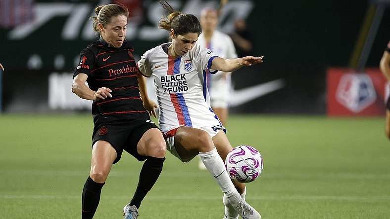 Jun 28, 2023; Portland, OR, USA; OL Reign forward McKenzie Weinert (51) kicks the ball past the Portland Throws FC during the second half at Providence Park. Mandatory Credit: Soobum Im-USA TODAY Sports