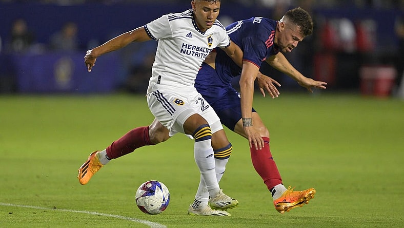 Aug 26, 2023; Carson, California, USA;  Los Angeles Galaxy midfielder Memo Rodriguez (20) and Chicago Fire midfielder Gaston Gimenez (30) battle for the ball in the first half at Dignity Health Sports Park. Mandatory Credit: Jayne Kamin-Oncea-USA TODAY Sports