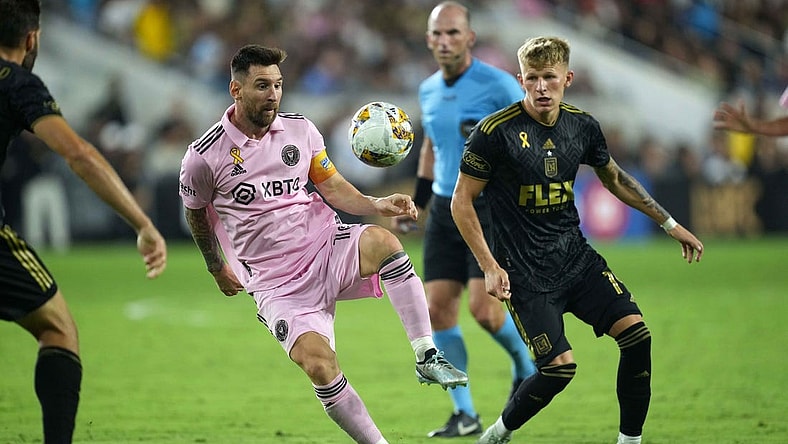 Sep 3, 2023; Los Angeles, California, USA; Inter Miami CF forward Lionel Messi (10) and LAFC midfielder Mateusz Bogusz (19) battle for the ball at BMO Stadium. Mandatory Credit: Kirby Lee-USA TODAY Sports
