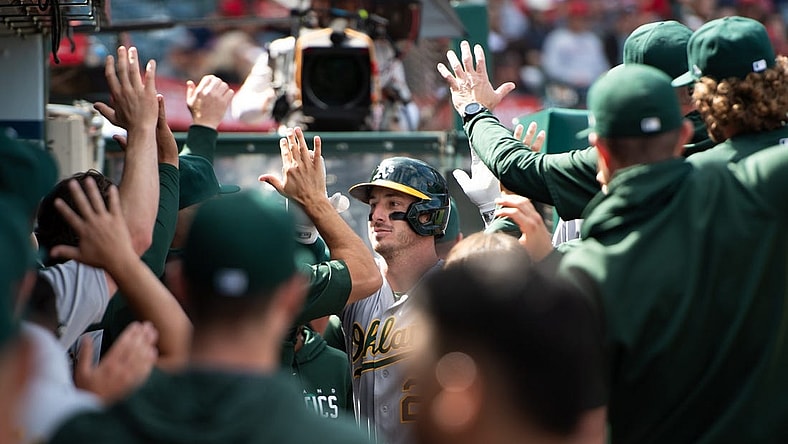 Oct 1, 2023; Anaheim, California, USA; Oakland Athletics designated hitter Brent Rooker (25) celebrates with teammates in the dugout after hitting a home run against the Los Angeles Angels during the eighth inning at Angel Stadium. Mandatory Credit: Jonathan Hui-USA TODAY Sports