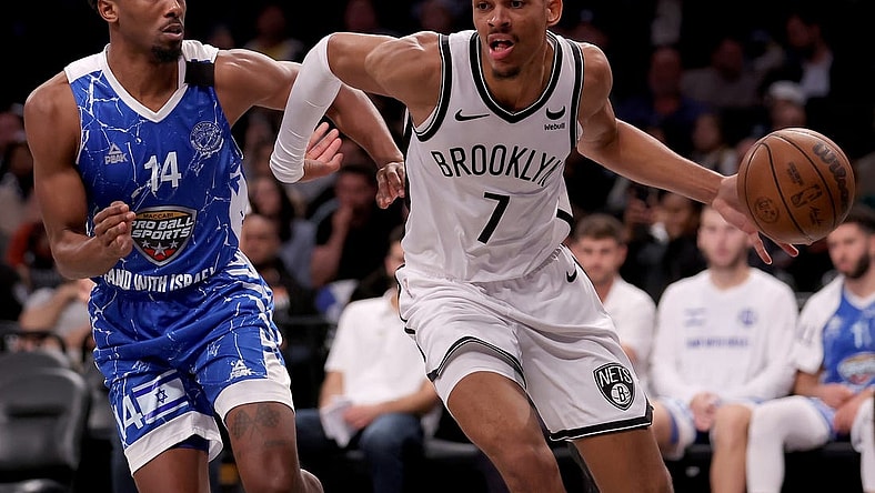 Oct 12, 2023; Brooklyn, NY, USA; Brooklyn Nets forward Darius Bazley (7) drives to the basket against Maccabi Ra'anana guard Dakarai Tucker (14) during the fourth quarter at Barclays Center. Mandatory Credit: Brad Penner-USA TODAY Sports