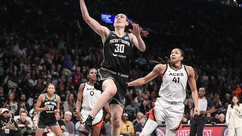 Oct 15, 2023; Brooklyn, New York, USA; New York Liberty forward Breanna Stewart (30) drives past Las Vegas Aces center Kiah Stokes (41) for a layup in the third quarter during game three of the 2023 WNBA Finals at Barclays Center. Mandatory Credit: Wendell Cruz-USA TODAY Sports
