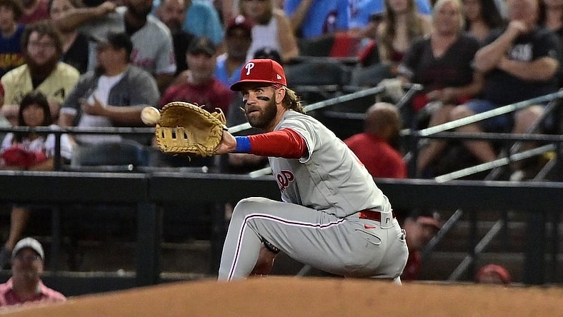 Oct 19, 2023; Phoenix, Arizona, USA; Philadelphia Phillies first baseman Bryce Harper (3) gets an out at first base against the Arizona Diamondbacks in the first inning during game three of the NLCS for the 2023 MLB playoffs at Chase Field. Mandatory Credit: Matt Kartozian-USA TODAY Sports
