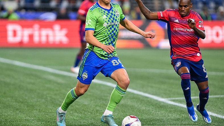 Nov 10, 2023; Seattle, Washington, USA; Seattle Sounders midfielder Josh Atencio (84) dribbles the ball as FC Dallas forward J  der Obrian (8) defends during the first half at Lumen Field. Mandatory Credit: Steven Bisig-USA TODAY Sports
