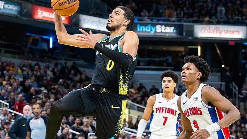Nov 24, 2023; Indianapolis, Indiana, USA; Indiana Pacers guard Tyrese Haliburton (0) shoots the ball while Detroit Pistons forward Ausar Thompson (9) defends in the second half at Gainbridge Fieldhouse. Mandatory Credit: Trevor Ruszkowski-USA TODAY Sports