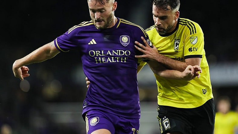 Nov 25, 2023; Orlando, Florida, USA; Orlando City forward Duncan McGuire (13) and Columbus Crew defender Rudy Camacho (4) battle for the ball during the second half in a MLS Cup Eastern Conference Semifinal match at Exploria Stadium. Mandatory Credit: Morgan Tencza-USA TODAY Sports