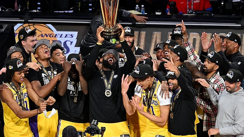 Dec 9, 2023; Las Vegas, Nevada, USA; Los Angeles Lakers forward LeBron James (23) hoists the NBA Cup and celebrates with teammates after winning the NBA In-Season Tournament Championship game against the Indiana Pacers at T-Mobile Arena. Mandatory Credit: Candice Ward-USA TODAY Sports