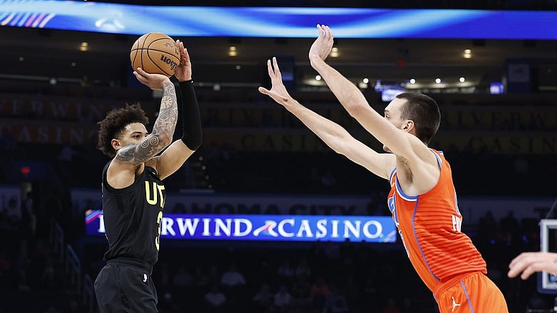 Dec 11, 2023; Oklahoma City, Oklahoma, USA; Utah Jazz guard Keyonte George (3) shoot a three-point basket as Oklahoma City Thunder forward Aleksej Pokusevski (17) defends during the second half at Paycom Center. Mandatory Credit: Alonzo Adams-USA TODAY Sports