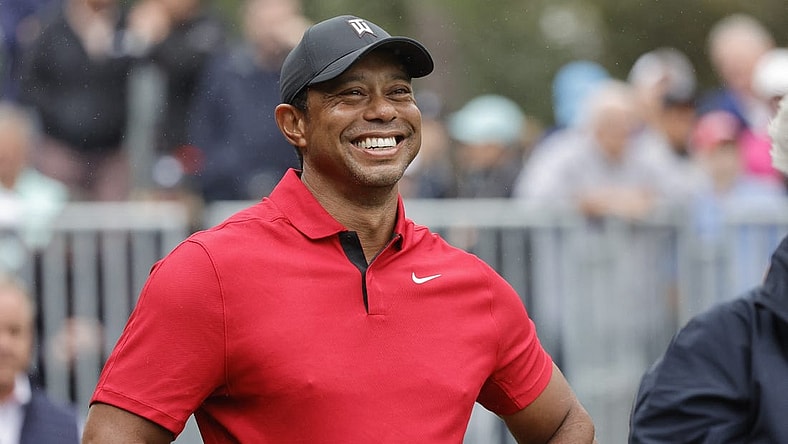 Dec 17, 2023; Orlando, Florida, USA;  Tiger Woods smiles before he plays his shot from the first tee during the PNC Championship at The Ritz-Carlton Golf Club. Mandatory Credit: Reinhold Matay-USA TODAY Sports