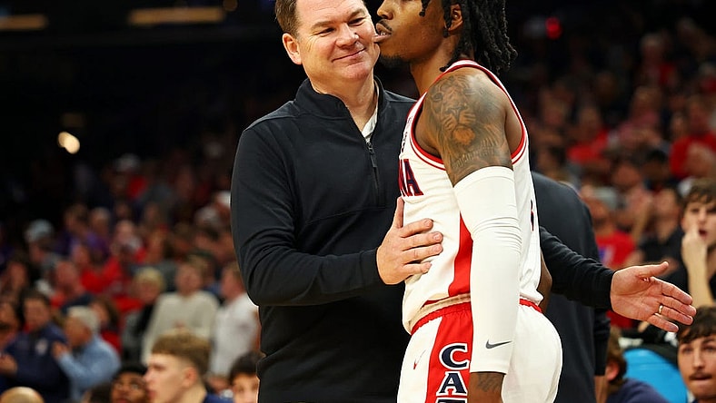 Dec 20, 2023; Phoenix, Arizona, USA; Arizona Wildcats head coach Tommy Lloyd talks to guard Caleb Love (2) during the second half of the game against the Alabama Crimson Tide in the Hall of Fame Series at Footprint Center. Mandatory Credit: Mark J. Rebilas-USA TODAY Sports