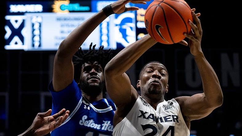 Xavier Musketeers forward Abou Ousmane (24) drops a pass as Seton Hall Pirates center Jaden Bediako (15) guards him in the second half of the basketball game between Xavier Musketeers and Seton Hall Pirates at the Cintas Center in Cincinnati on Saturday, Dec. 23, 2023.
