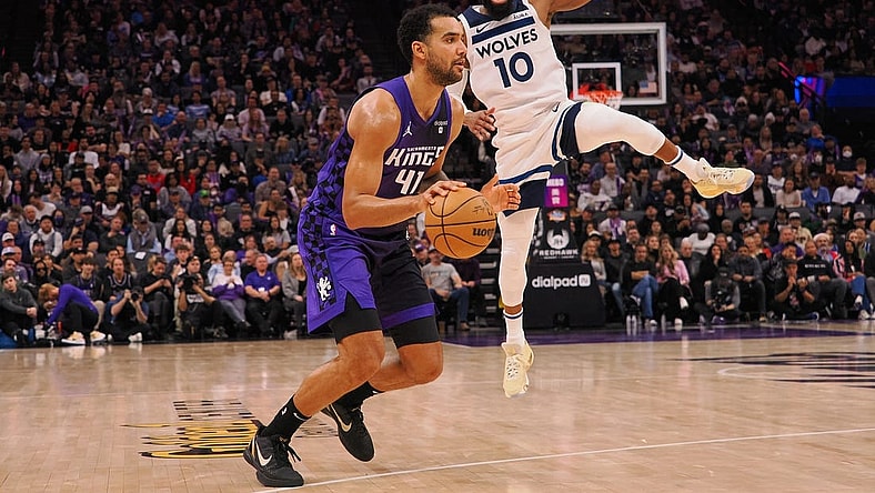 Dec 23, 2023; Sacramento, California, USA; Sacramento Kings forward Trey Lyles (41) controls the ball against Minnesota Timberwolves guard Mike Conley (10) during the fourth quarter at Golden 1 Center. Mandatory Credit: Kelley L Cox-USA TODAY Sports