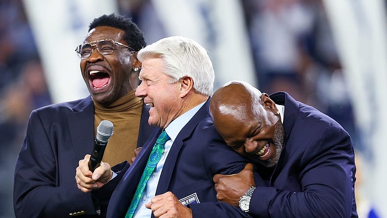 Dec 30, 2023; Arlington, Texas, USA;  Dallas Cowboys former head coach Jimmy Johnson celebrates with former players Michael Irvin and Emmitt Smith after being inducted into the ring of honor at halftime of the game against the Detroit Lions at AT&T Stadium. Mandatory Credit: Kevin Jairaj-USA TODAY Sports