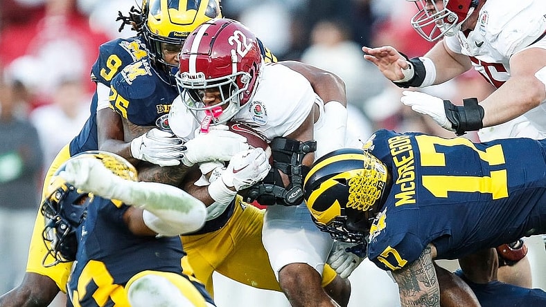 Alabama running back Justice Haynes (22) runs against Michigan defensive end Braiden McGregor (17) during the second half of the Rose Bowl in Pasadena, Calif., on Monday, Jan. 1, 2024.