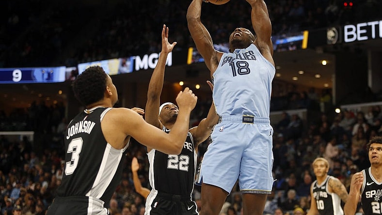 Jan 2, 2024; Memphis, Tennessee, USA; Memphis Grizzlies center Bismack Biyombo (18) collects a rebound over San Antonio Spurs guard Malaki Branham (22) during the first half at FedExForum. Mandatory Credit: Petre Thomas-USA TODAY Sports
