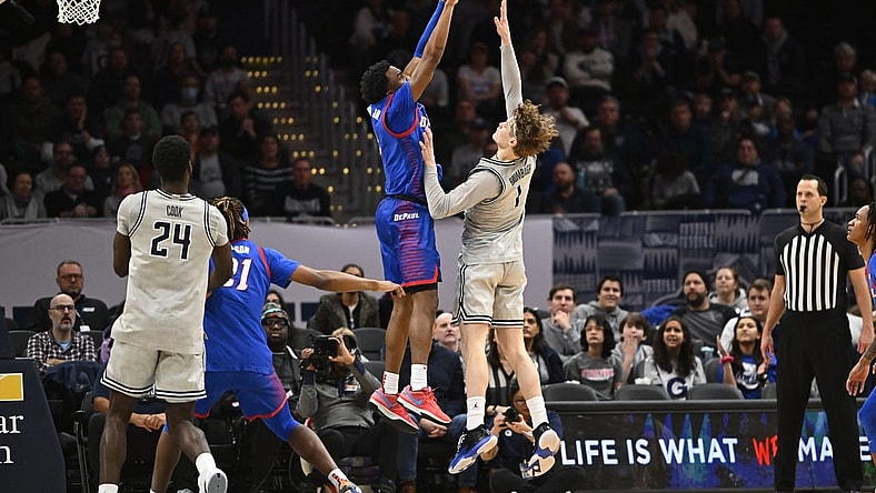 Jan 6, 2024; Washington, District of Columbia, USA; Georgetown Hoyas guard Rowan Brumbaugh (1) shoots over DePaul Blue Demons guard Chico Carter Jr. (2) during the second half at Capital One Arena. Mandatory Credit: Brad Mills-USA TODAY Sports