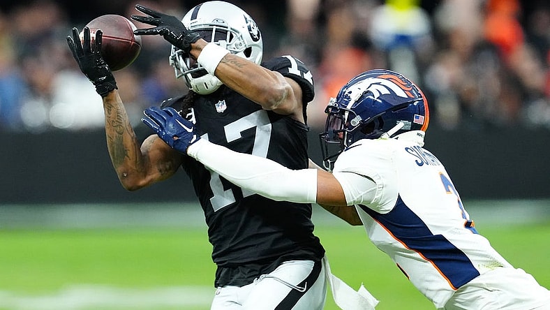 Jan 7, 2024; Paradise, Nevada, USA; Las Vegas Raiders wide receiver Davante Adams (17) makes a catch against Denver Broncos cornerback Pat Surtain II (2) during the second quarter at Allegiant Stadium. Mandatory Credit: Stephen R. Sylvanie-USA TODAY Sports