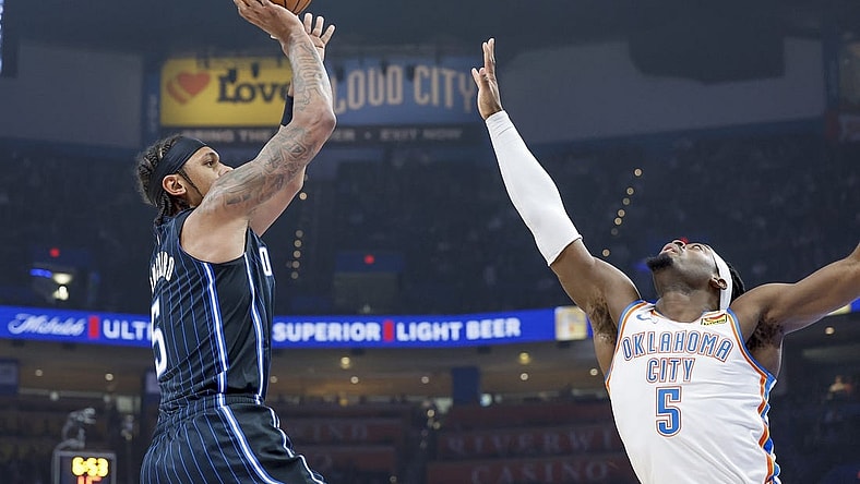 Jan 13, 2024; Oklahoma City, Oklahoma, USA; Orlando Magic forward Paolo Banchero (5) shoots as Oklahoma City Thunder guard Luguentz Dort (5) defends during the first quarter at Paycom Center. Mandatory Credit: Alonzo Adams-USA TODAY Sports