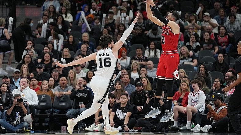 Jan 13, 2024; San Antonio, Texas, USA; Chicago Bulls guard Zach LaVine (8) shoots over San Antonio Spurs forward Cedi Osman (16) in the second half at Frost Bank Center. Mandatory Credit: Daniel Dunn-USA TODAY Sports