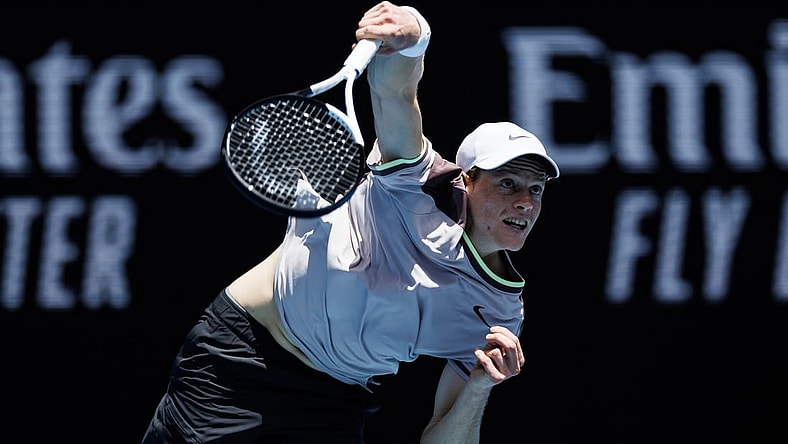 Jan 14, 2024; Melbourne, Victoria, Australia;   Jannik Sinner of Italy hits a shot against Botic Van De Zandschulp of the Netherlands in the first round of the men s singles. Mandatory Credit: Mike Frey-USA TODAY Sports