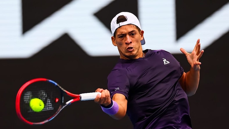 Jan 19, 2024; Melbourne, Victoria, Australia; Sebastian Baez of Argentina plays a shot against Jannik Sinner (not pictured) of Italy in Round 3 of the Men's Singles on Day 6 of the Australian Open tennis at Margaret Court Arena. Mandatory Credit: Mike Frey-USA TODAY Sports